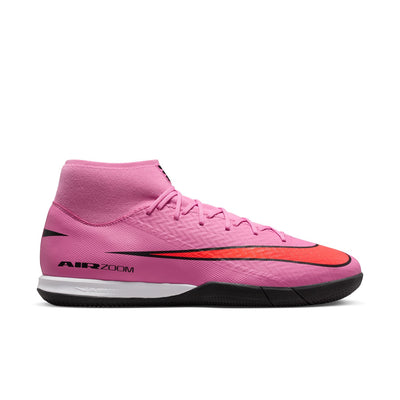 Pink soccer cleat with black and red accents on a white background